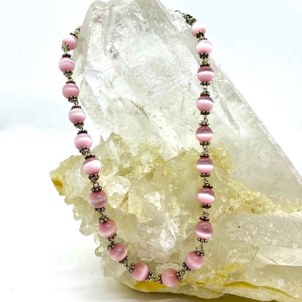 Pink beaded necklace with silver accents and heart closure
